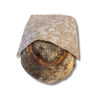 Photo of a paper bread bag with a sourdough loaf inside.