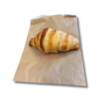 Photo of a paper bread bag with a croissant roll.